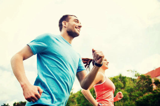 Man and woman happily running outdoors